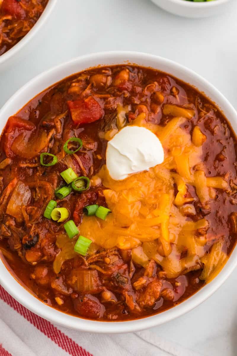 closeup of the Pulled Pork Chili served in a white bowl.