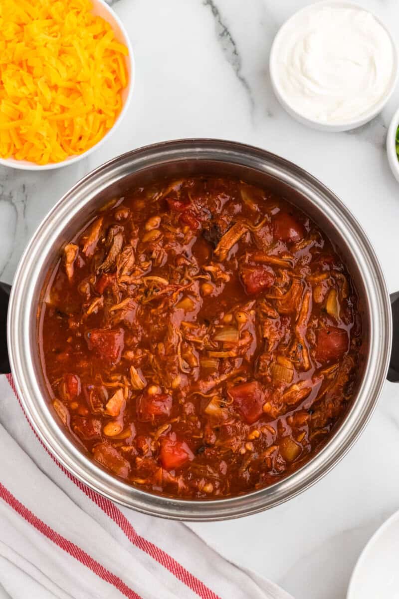 top-down view of the Pulled Pork Chili mixed in a large pot.