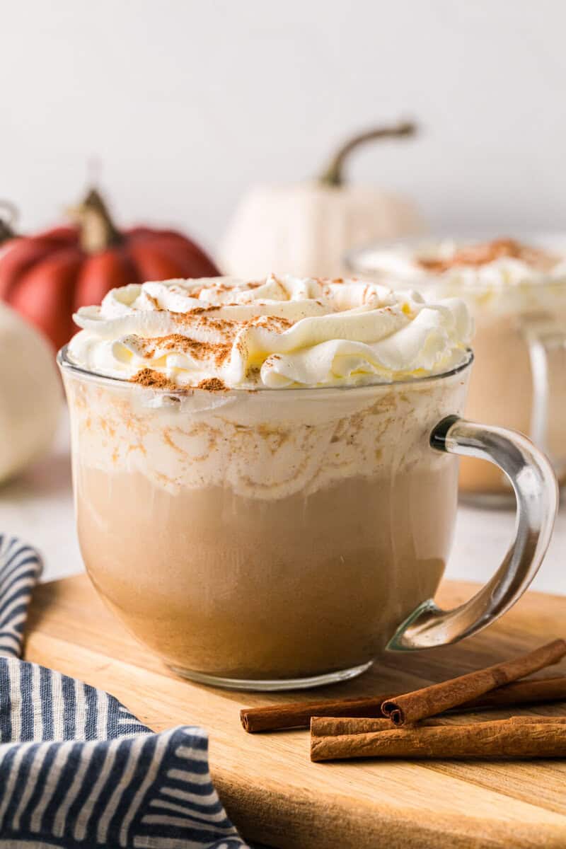 closeup of a pumpkin spice latte in a clear mug.