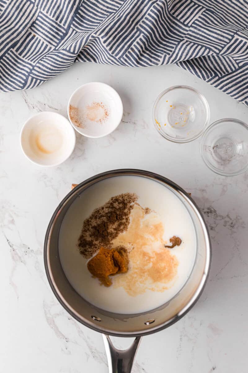 heating the milk and pumpkin together.