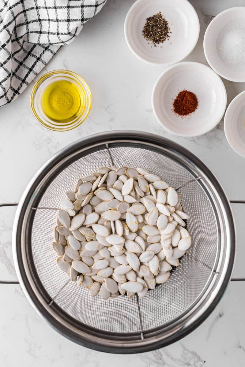 washed pumpkin seeds in a strainer.