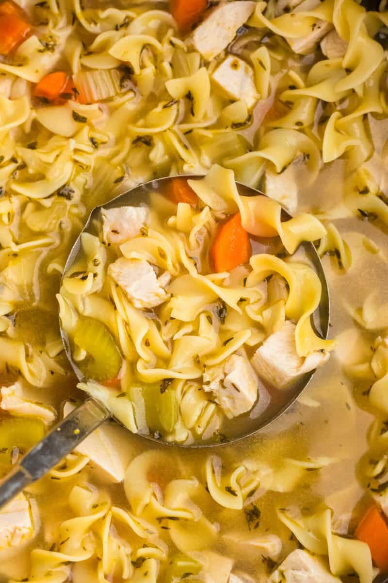 closeup of the Turkey Noodle Soup being served with a ladle.