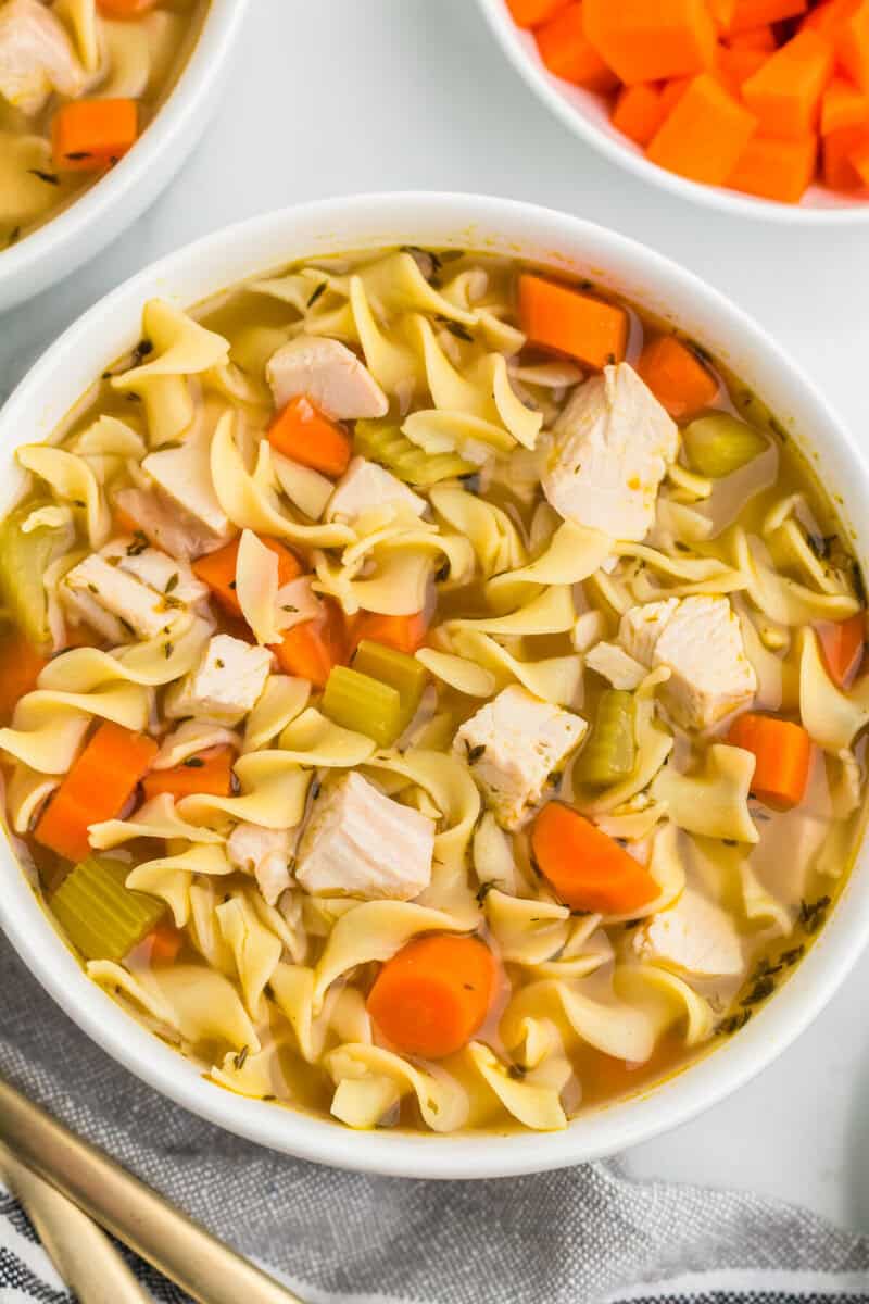 top-down view of the Turkey Noodle Soup served in a white bowl.