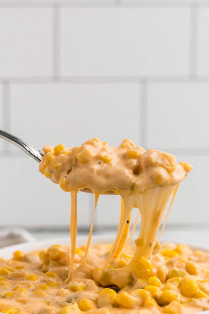 serving the Cheesy Corn with a metal spoon.