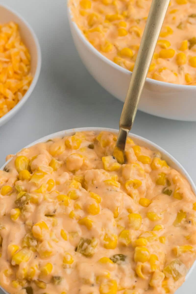 closeup of the Cheesy Corn with a spoon in it.