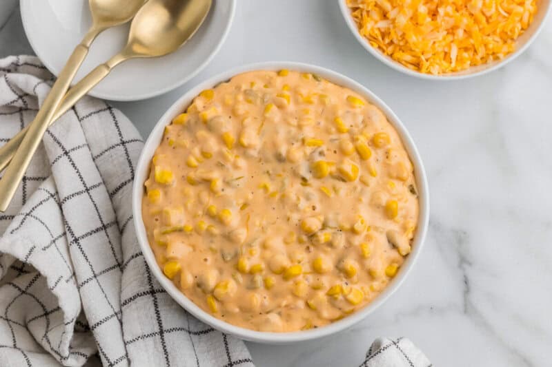 top-down view of the Cheesy Corn served in a white bowl.