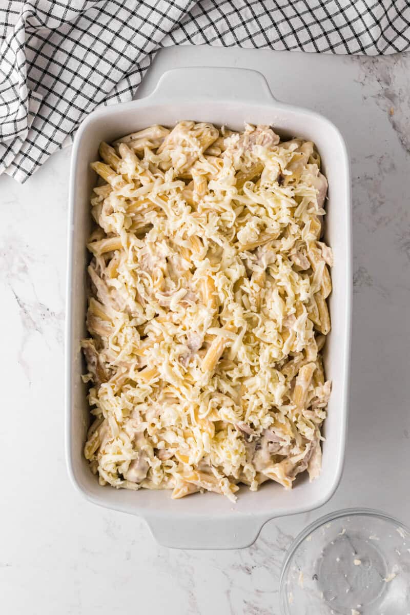 topping the chicken alfredo bake with mozzarella cheese.