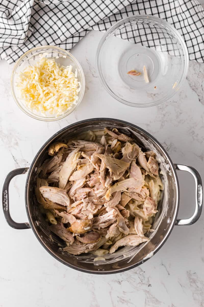 adding the chicken to the pot.