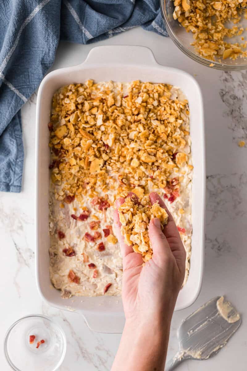 sprinkling the crushed Ritz crackers on top of the casserole.