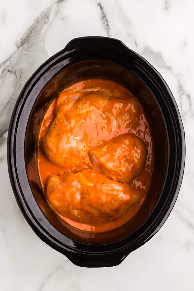 chicken with buffalo sauce in the slow cooker.