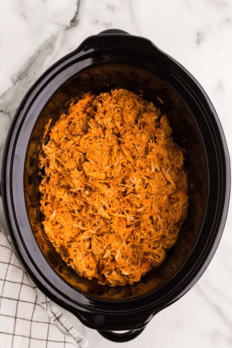 buffalo chicken shredded in the slow cooker.