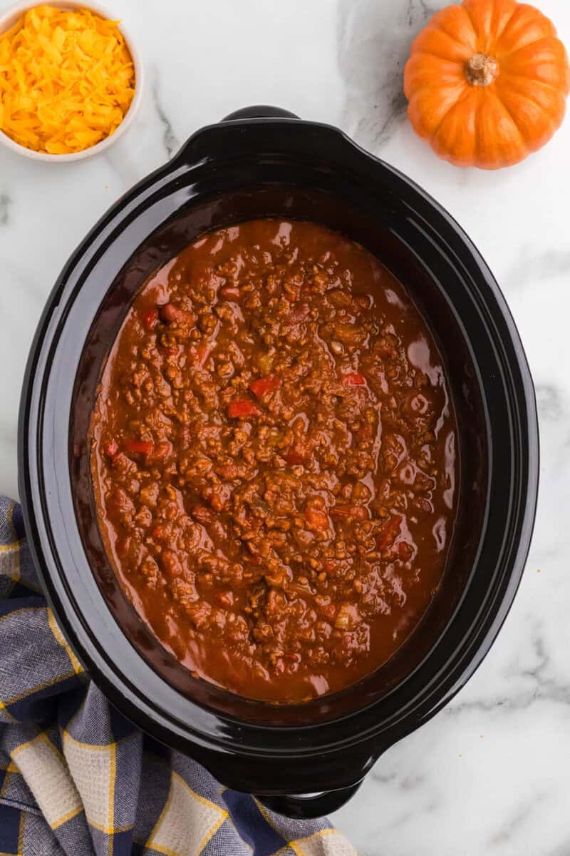 top-down view of inside the slow cooker with the pumpkin chili.