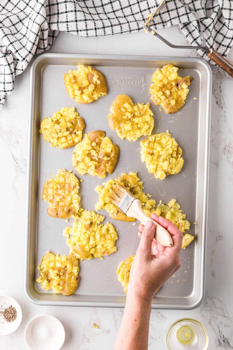 brushing the smashed potatoes with oil.