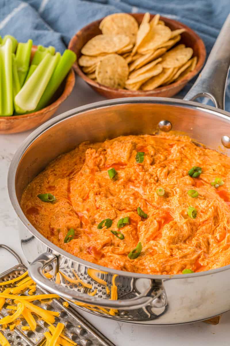 Buffalo Chicken Dip in a saucepan cooking.