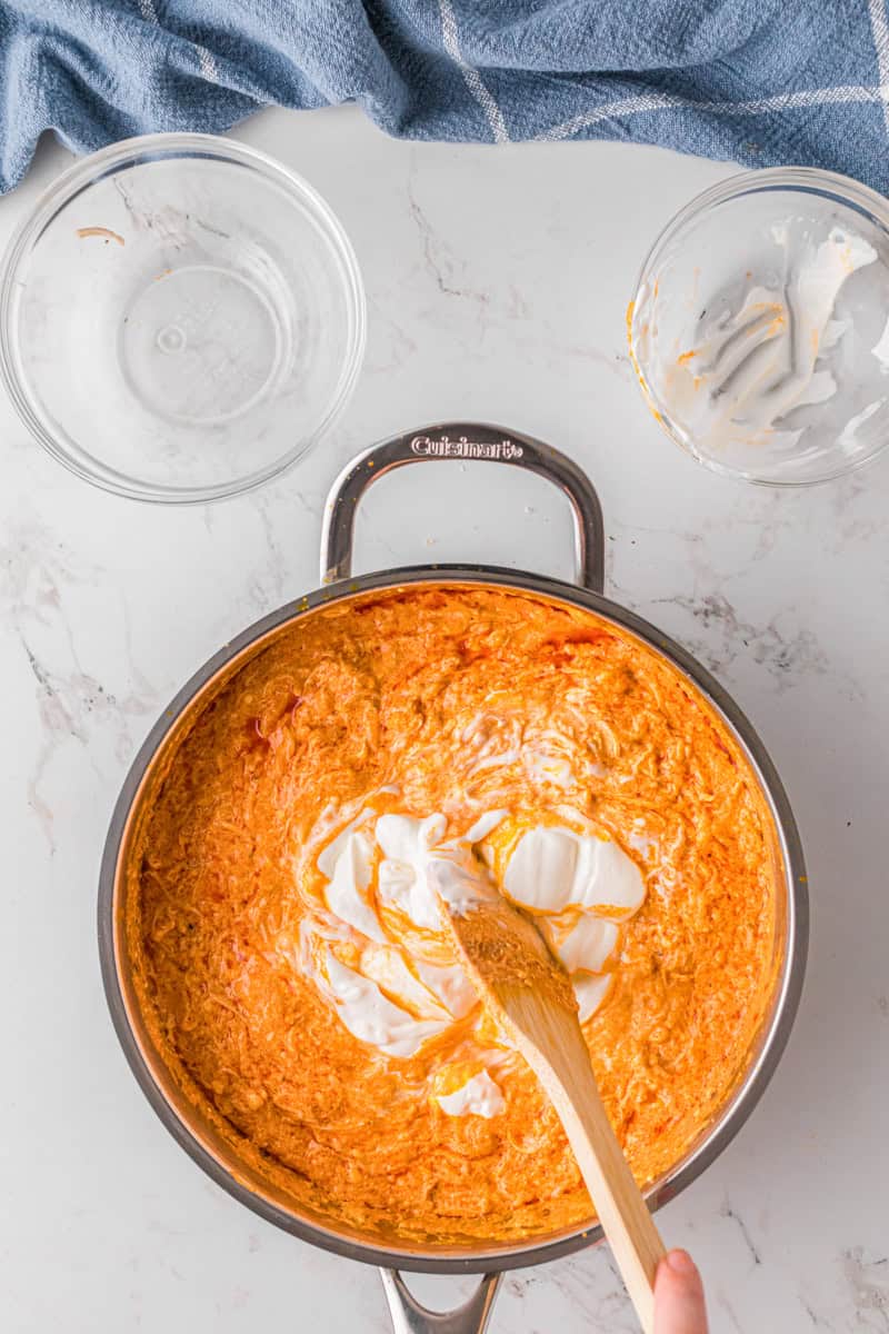 mixing in the sour cream to the dip.