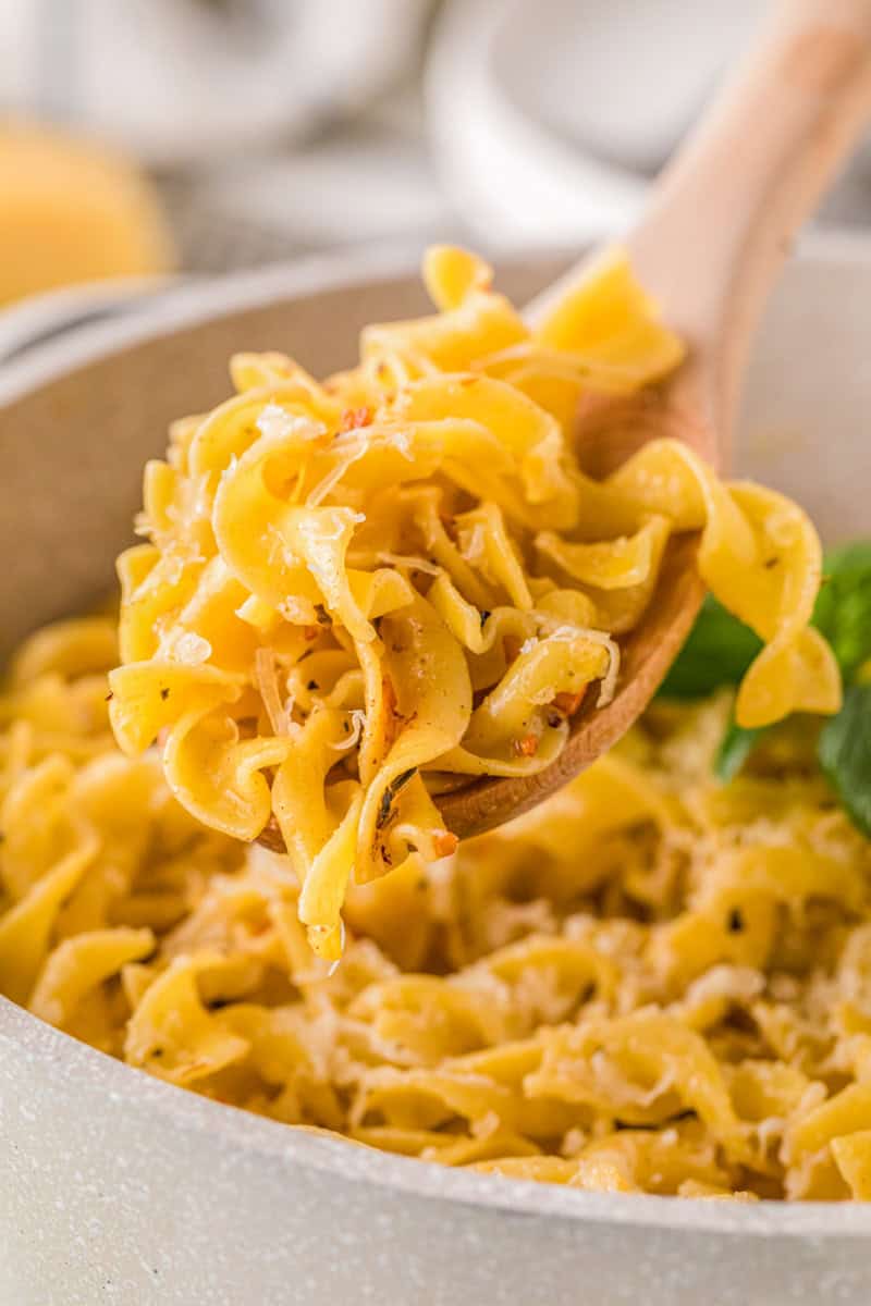 serving the butter noodles out of the pot.