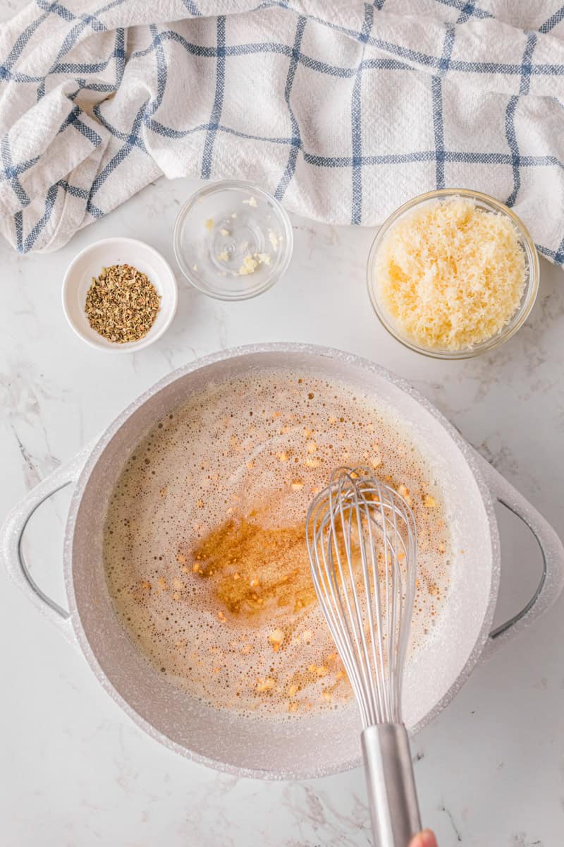heating the butter and garlic in a pan.