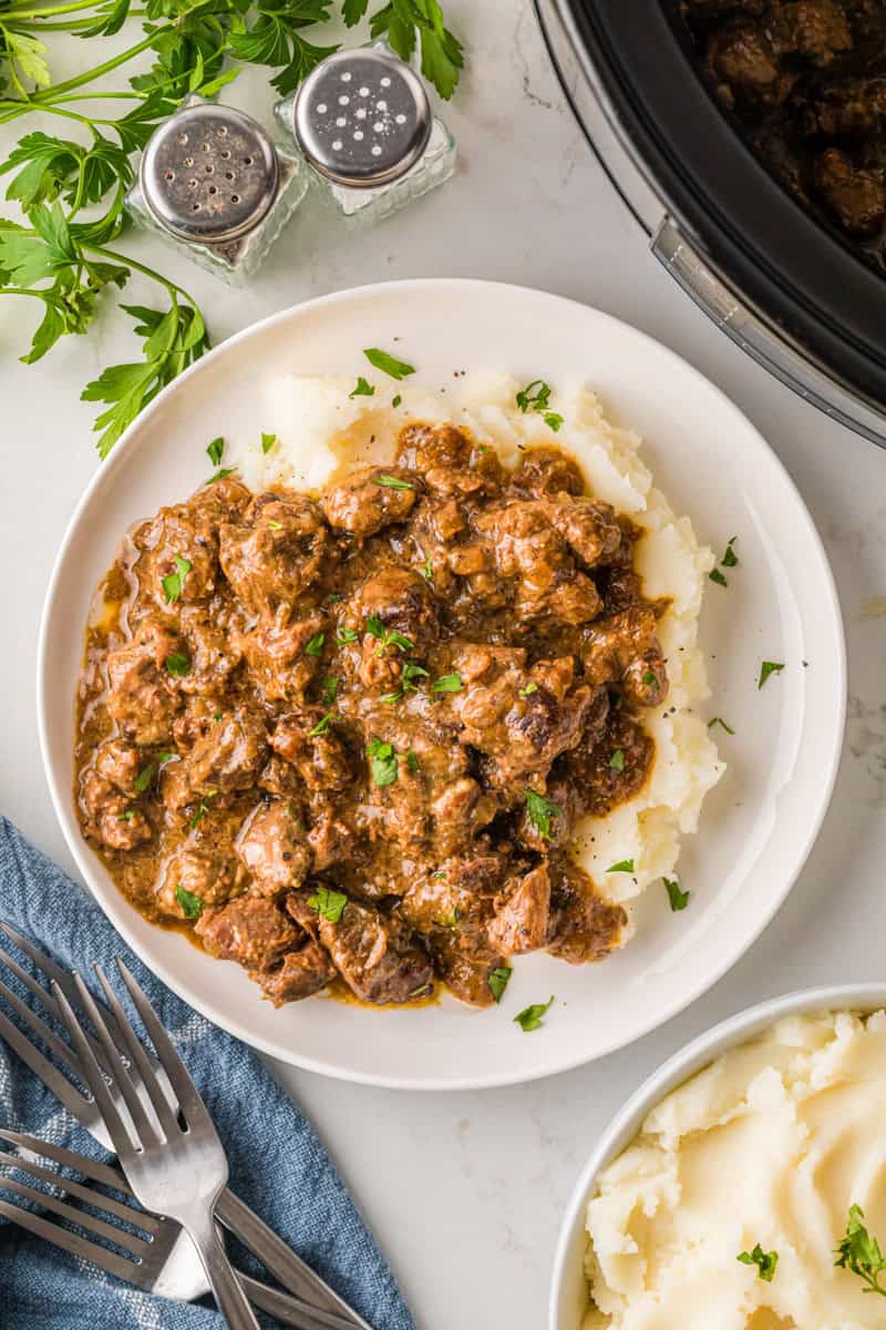 top-down view of the beef tips served on top of mashed potatoes.