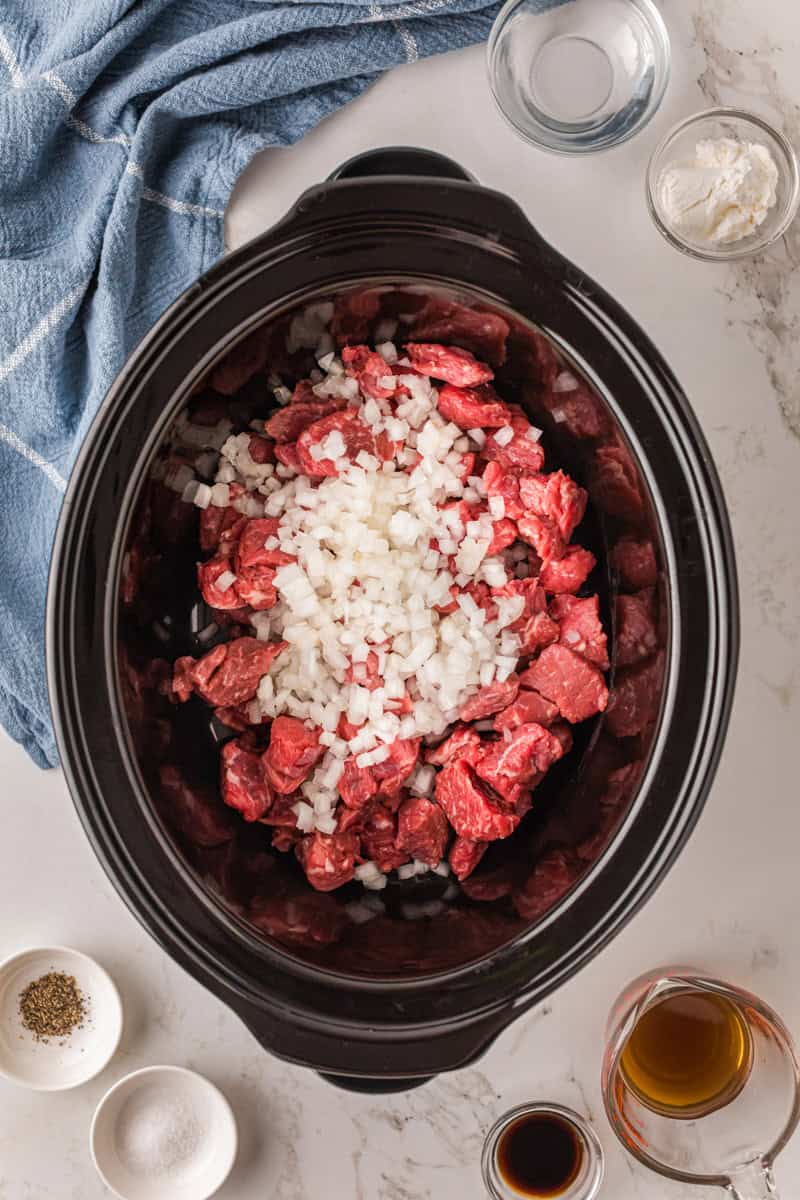 beef and onions in the slow cooker.