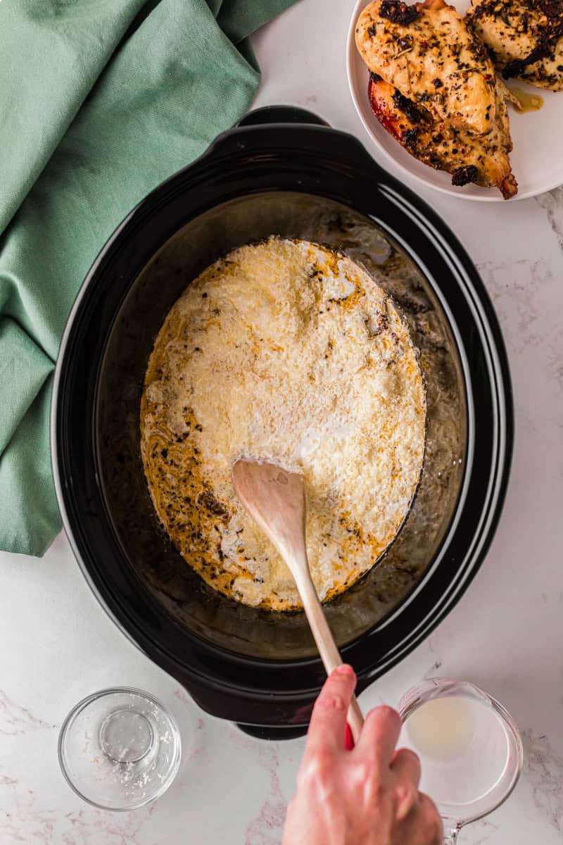 mixing together the ingredients in the slow cooker.