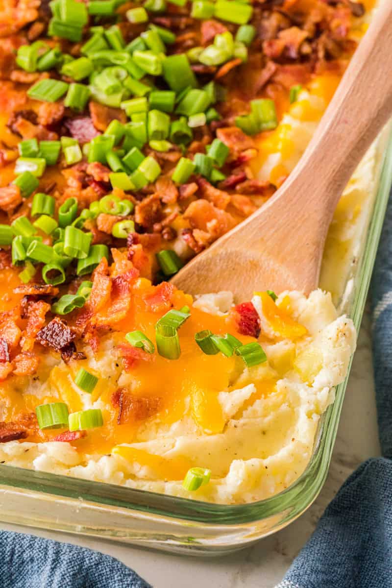 serving the loaded mashed potatoes out of the dish with a wooden spoon.