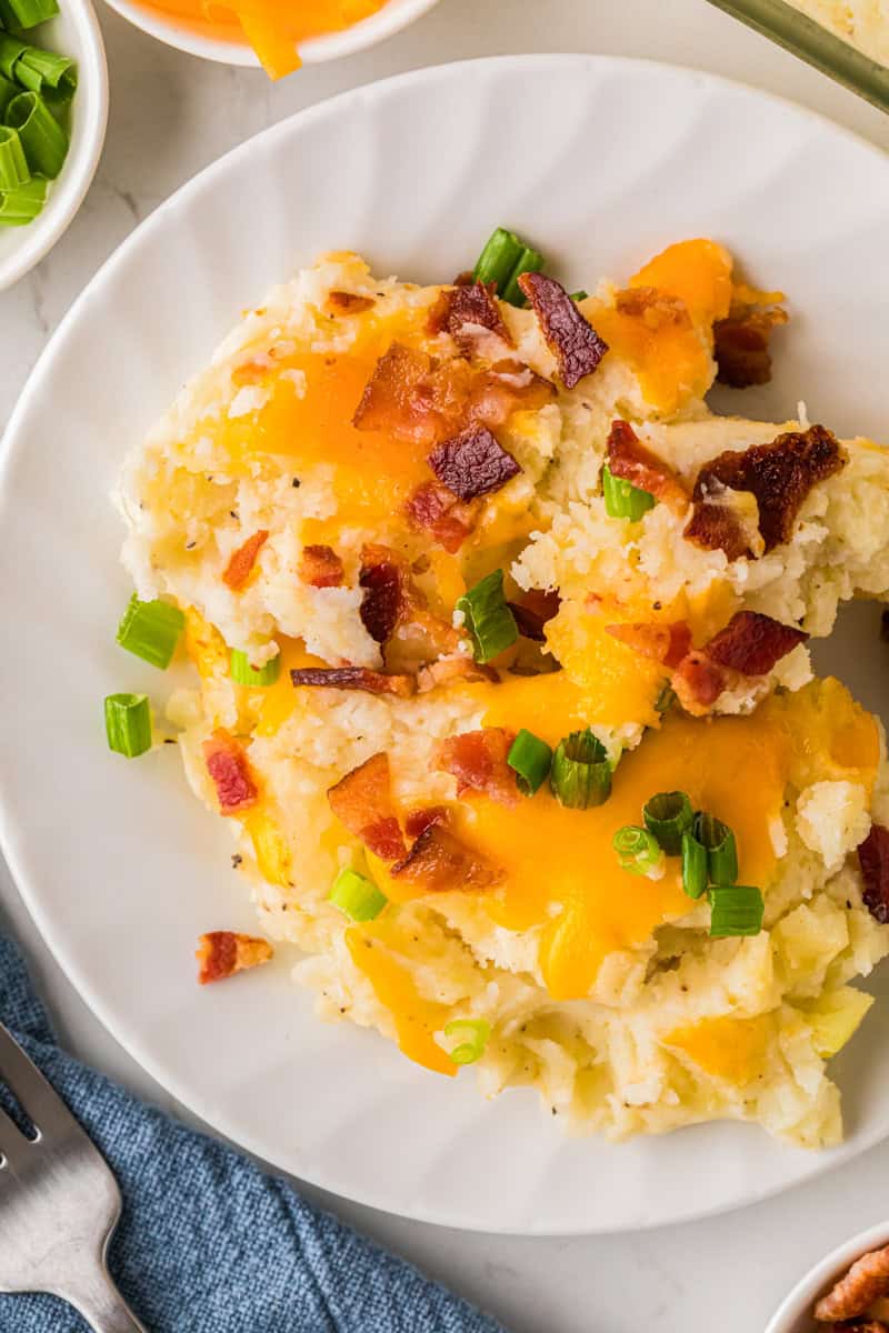 top-down view of the loaded mashed potatoes served on a white plate.