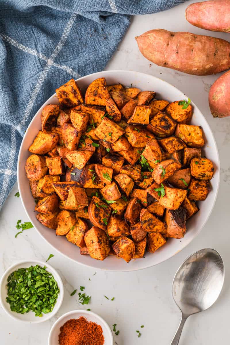 top-down of the roasted sweet potatoes in a white bowl.