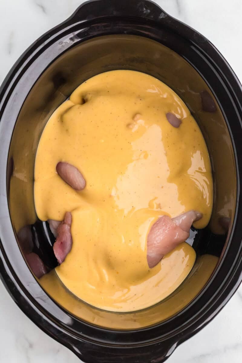 pouring the soup on top of the chicken.