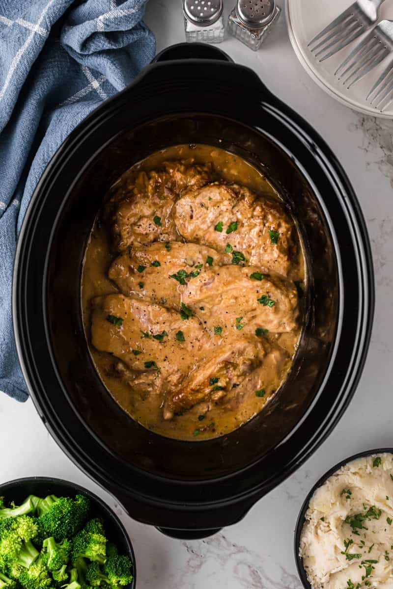 top-down view of the pork chops cooked in a slow cooker.