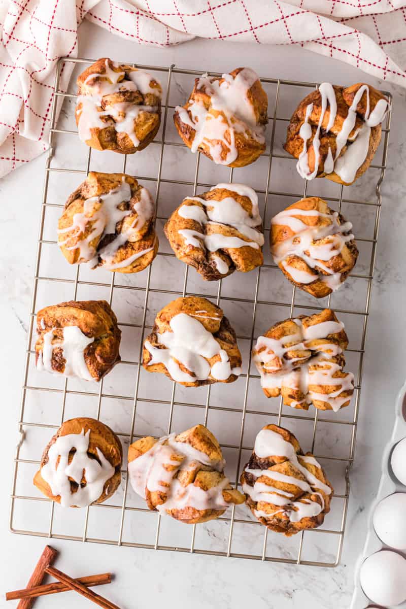cinnamon roll muffins on cooling rack.