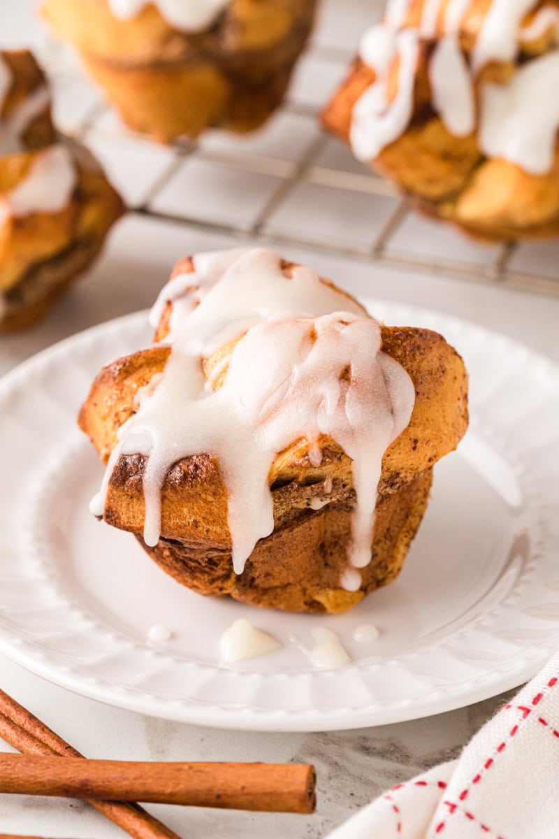 closeup of the cinnamon roll muffins on a white plate.