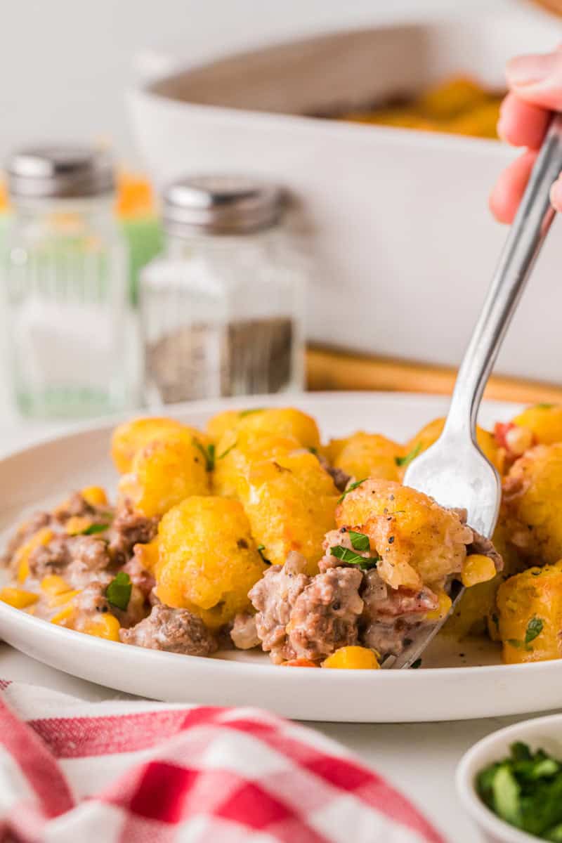 using a fork to eat the Cowboy Casserole.