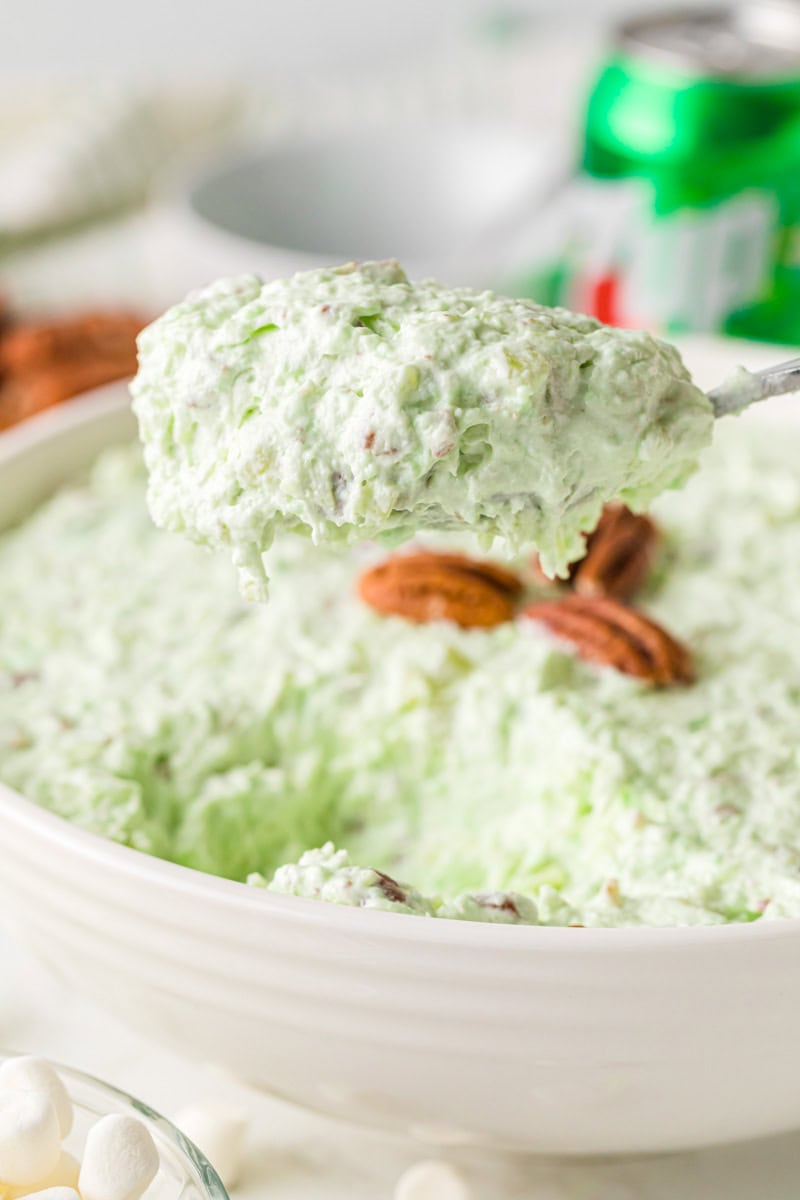 serving the 7-Up Salad with a metal spoon.