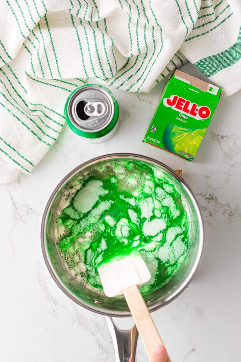 mixing together the Jell-O with the 7-Up.