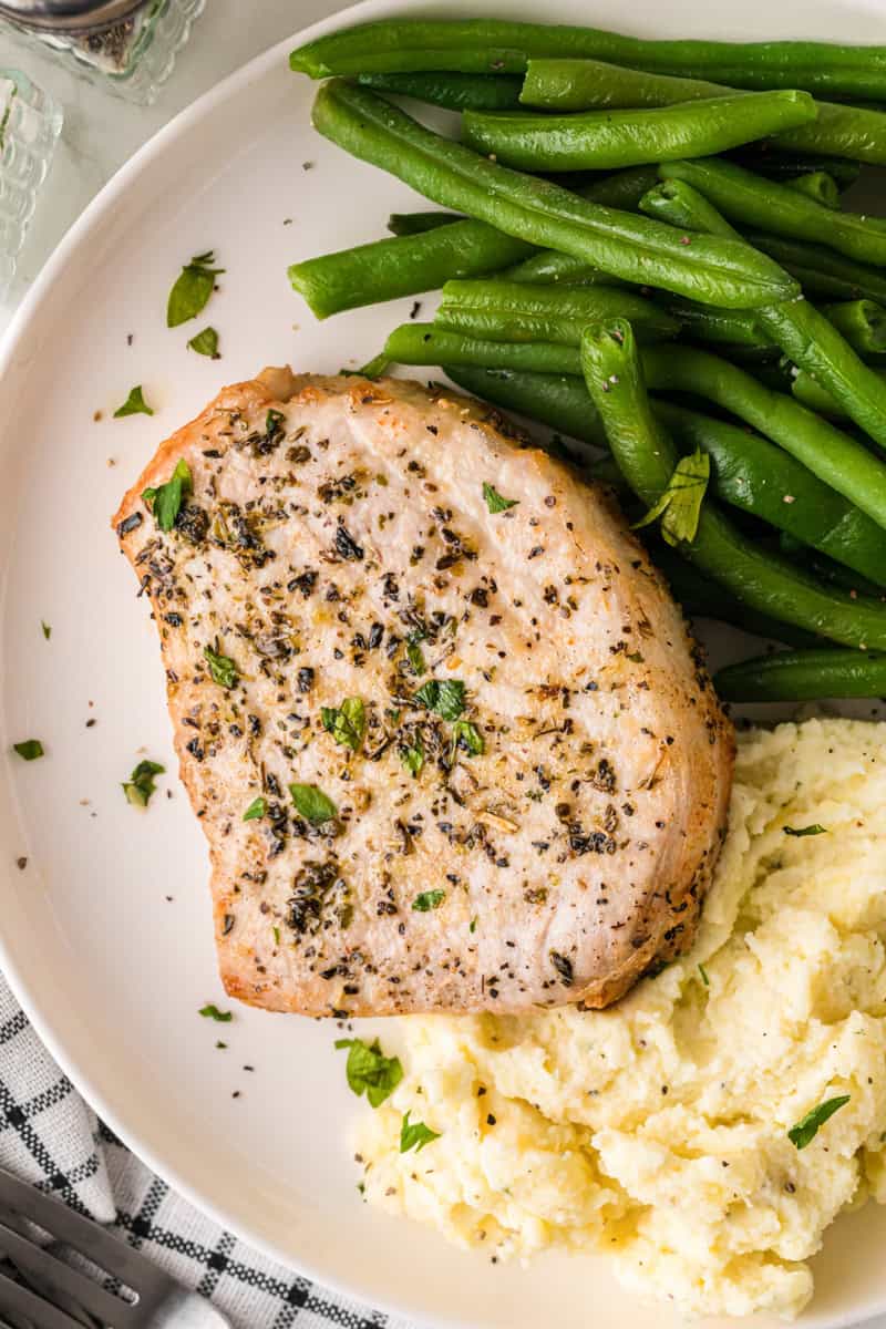 top-down closeup of the Air fryer Pork Chops served on a white plate.