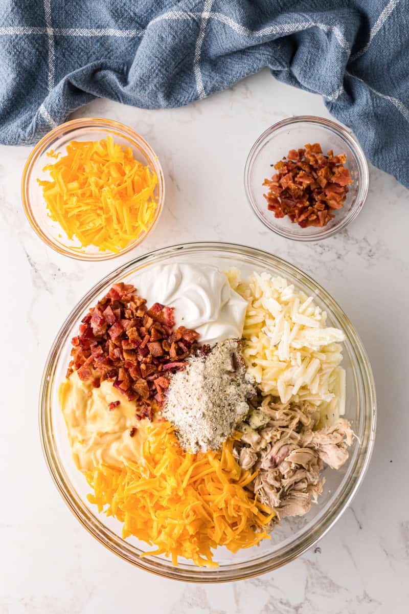 ingredients for the Crack Chicken Casserole in a large clear bowl.