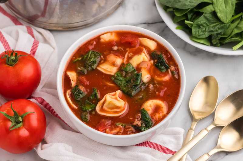 top-down view of the Italian Sausage Tortellini Soup served in a white bowl.