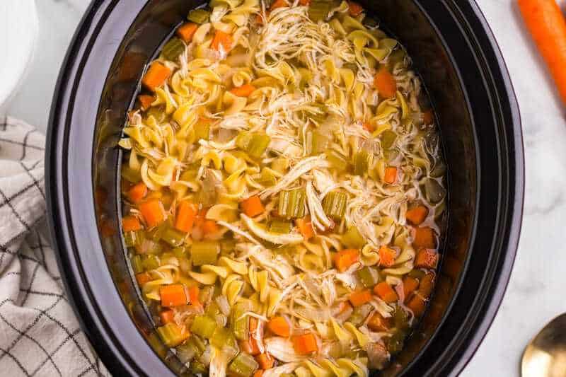 top-down view of the Chicken Noodle Soup in the slow cooker.