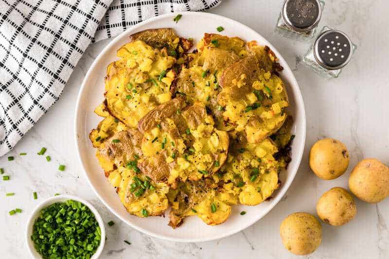 top-down view of the Smashed Potatoes on a white serving plate.