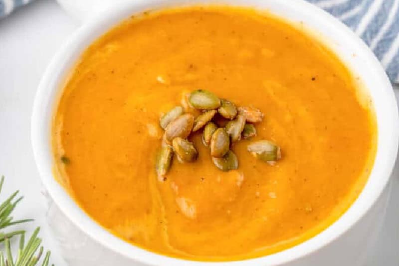 closeup of the Butternut Squash Soup served in a white bowl.
