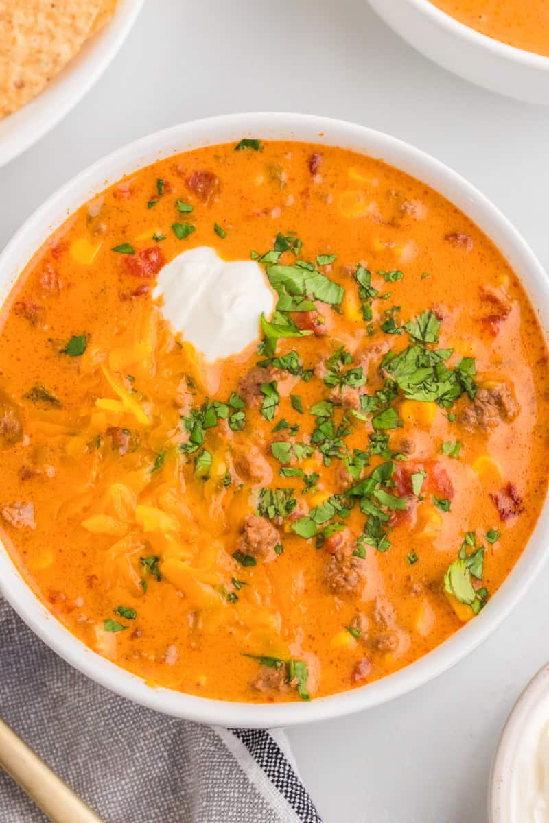 closeup of the Beef Nacho Soup served in a white bowl.