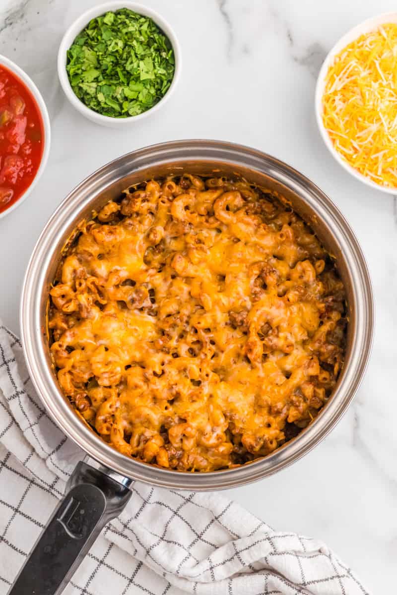 One Pan Taco Pasta in the pan topped with cheese.