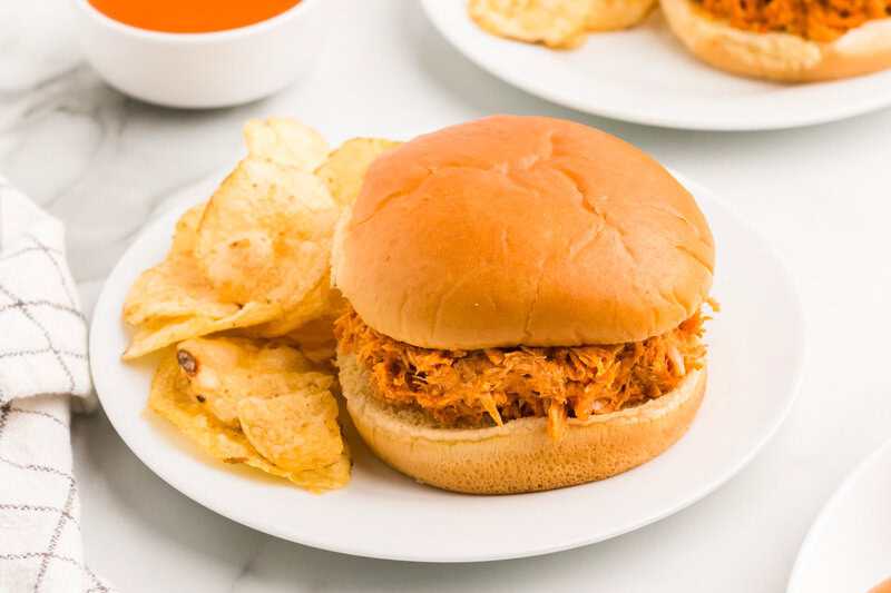Buffalo Chicken Sandwich on a plate with chips.