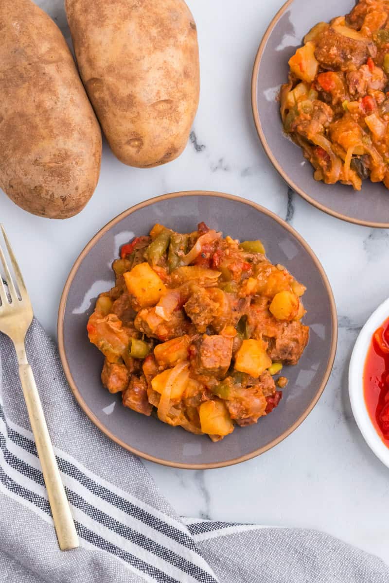 top-down view of the steak and potatoes served on a plate.