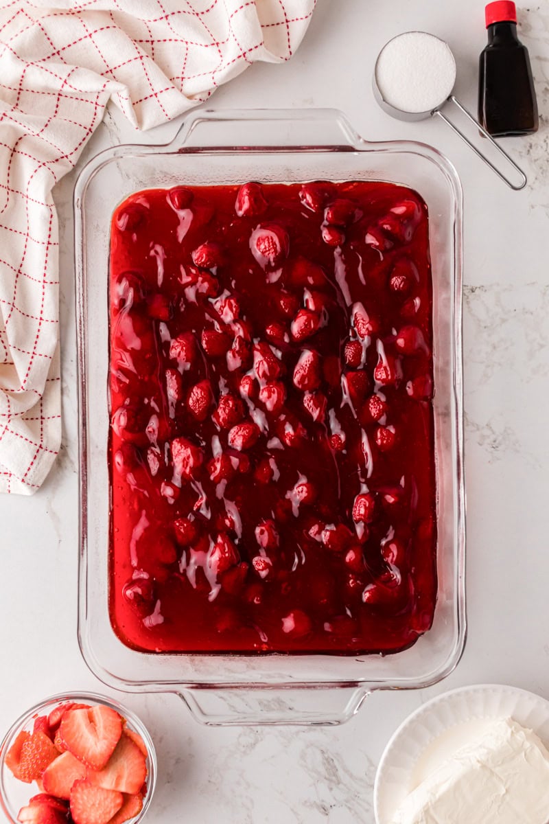 preparing the dump cake in the bottom of the baking dish.