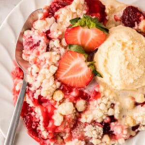 Strawberry Cheesecake Dump Cake recipe card picture on recipe on plate