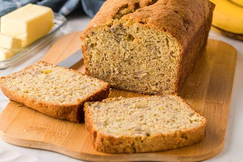 3 Ingredient Banana Bread sliced on wooden serving board.