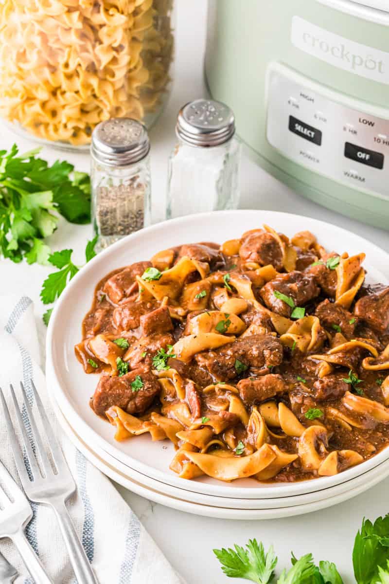 Slow Cooker Beef and Noodles served on white plates.