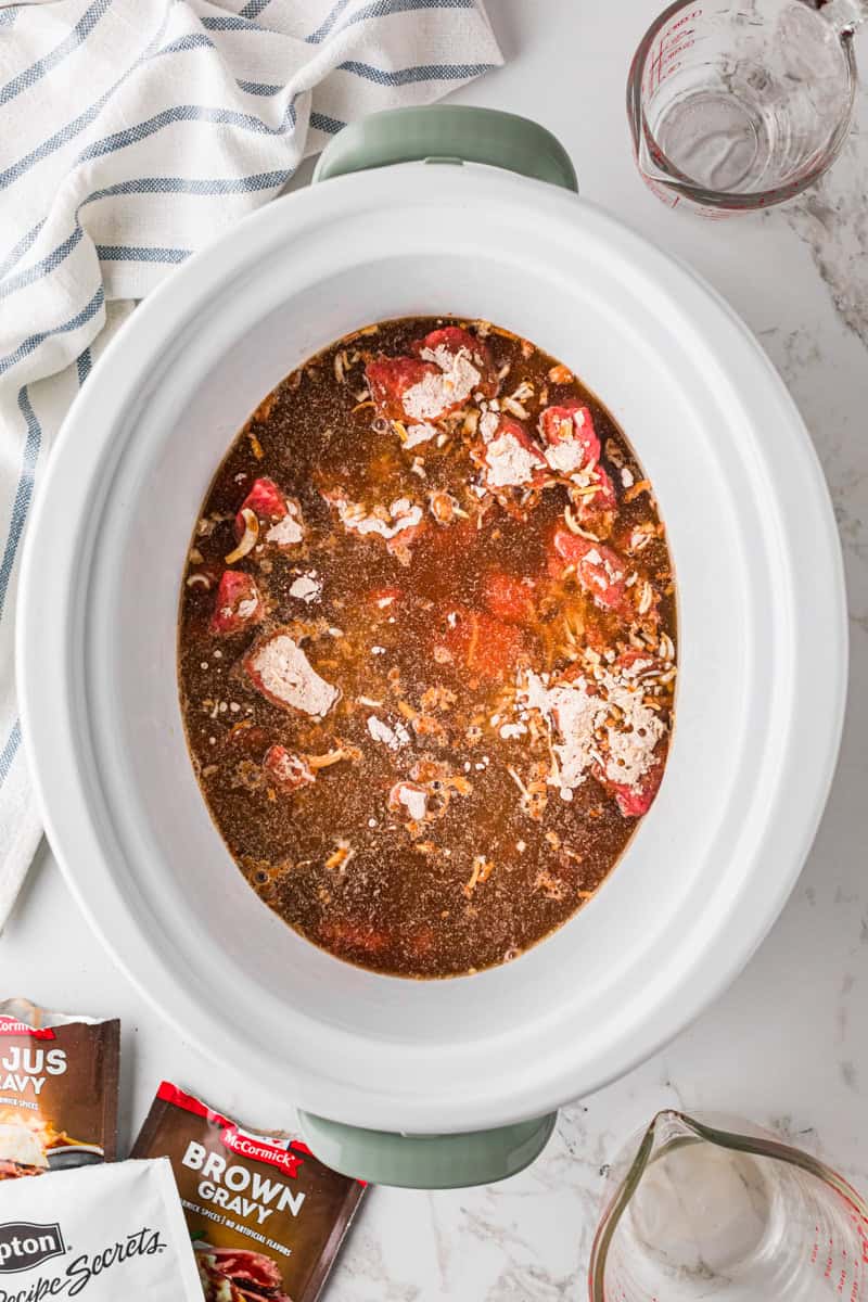 the beef and ingredients cooking in the slow cooker.