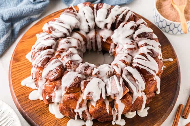 Cinnamon Roll Monkey Bread served on a wooden board.